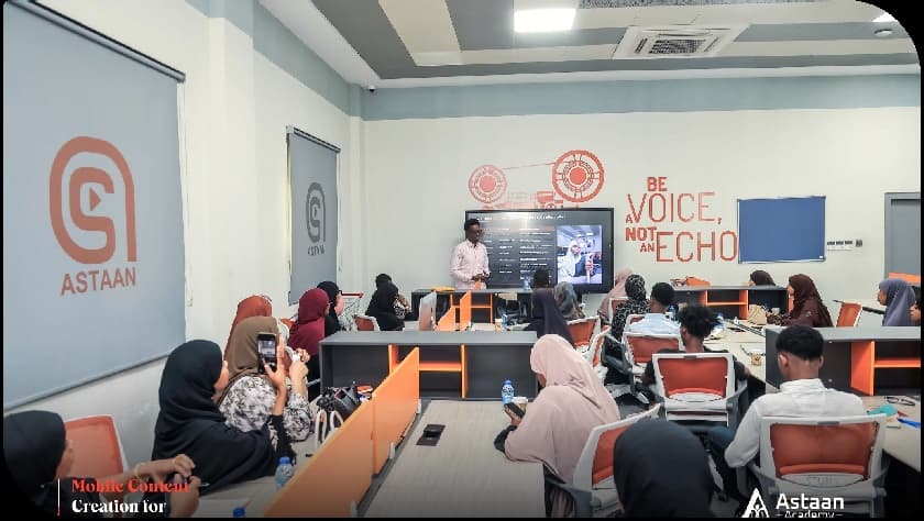 Participants watch a presentation during a mobile content creation training at Astaan Academy