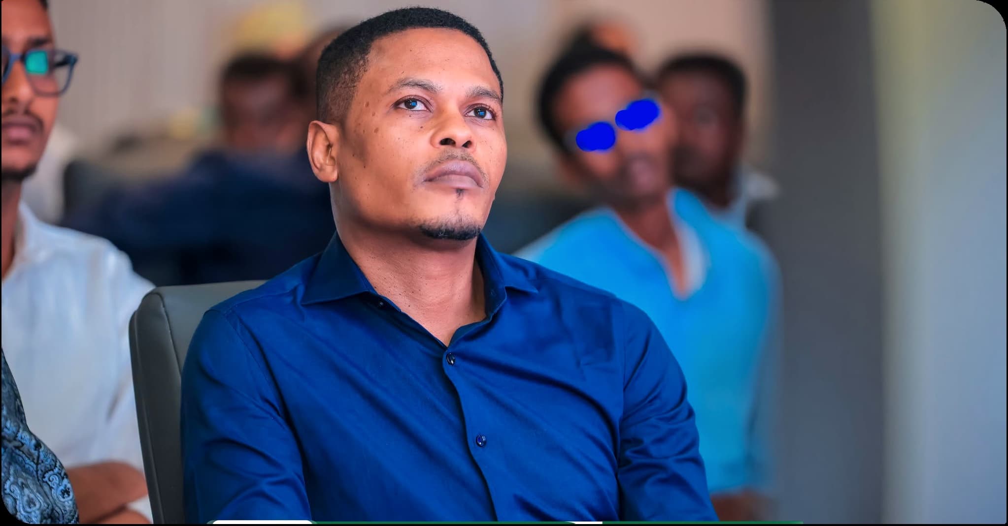 An attendee in a blue shirt listens attentively at the research report launch event
