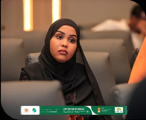 A participant follows the panel discussion from her seat