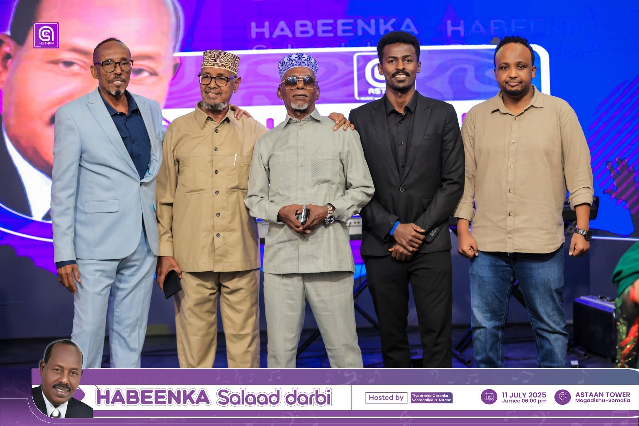 Five guests lined up across the tribute stage under purple LED light at Habeenka Salaad Darbi.