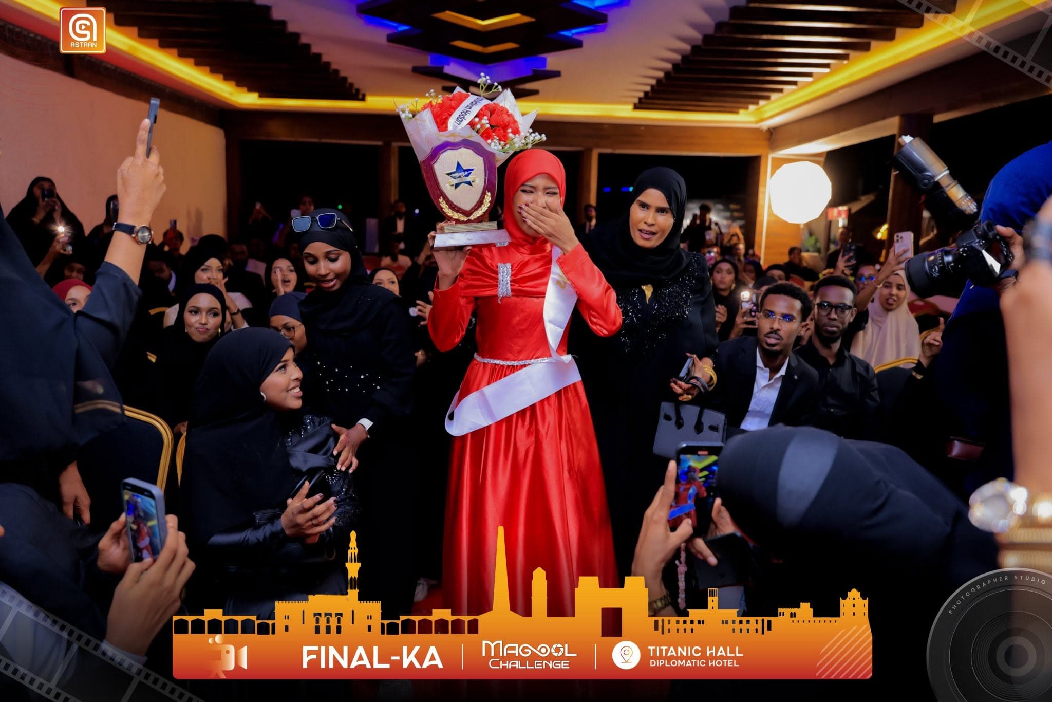 The Magool Challenge winner lifting her trophy among the crowd at the Titanic Hall final